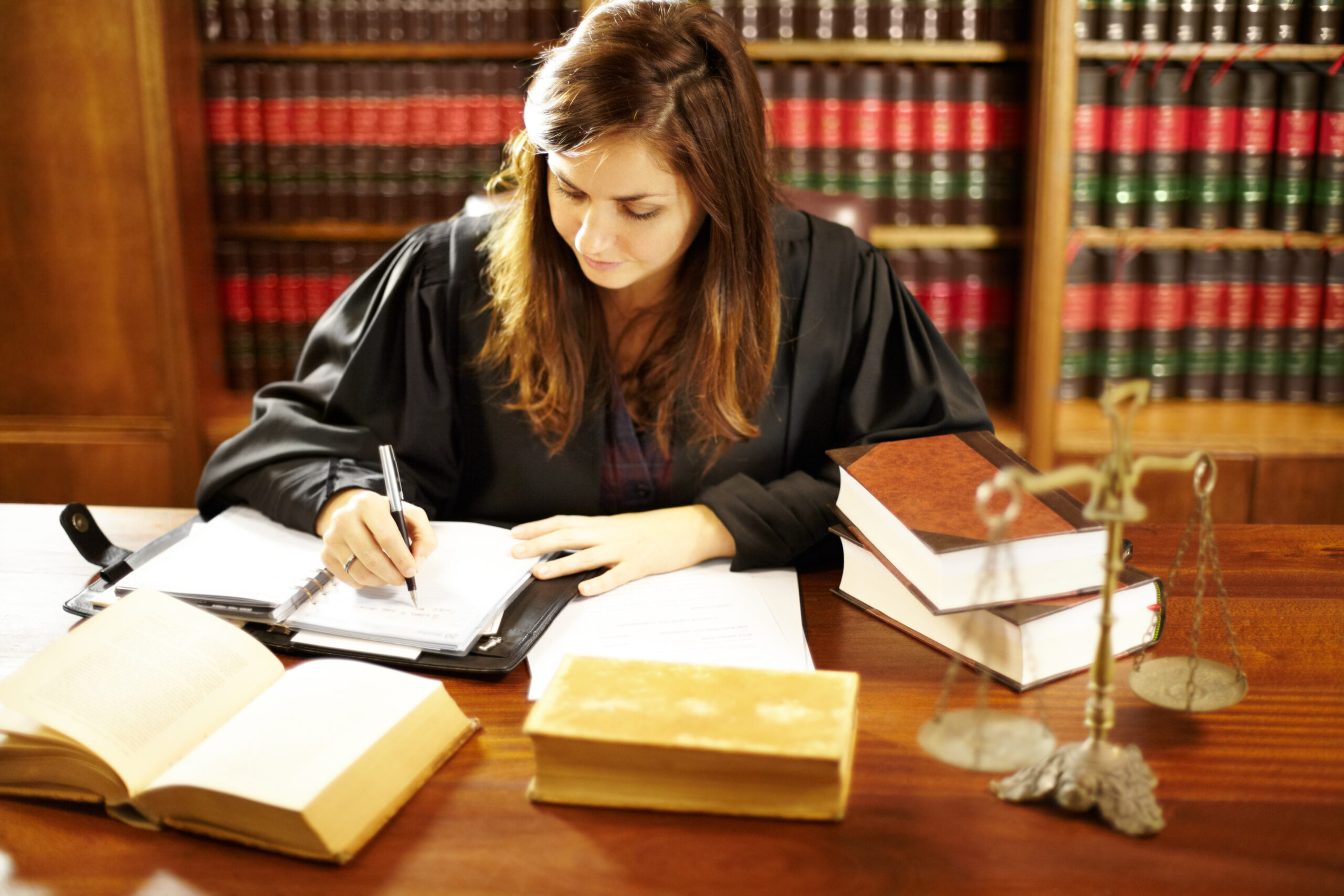 Shot of a young legal professional sitting at her desk in a study.